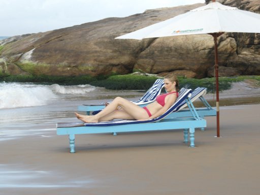 Picture of a European woman sitting on a sunbed and enjoying the beach at Manaltheeram